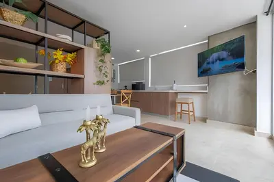 a living room with a couch and a table at Laurdhomes Laguito Loft Hot Ware 1Bath, lake view in Cartagena de Indias