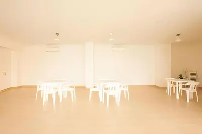 a room with white tables and white chairs at Laurdhomes Laguito Loft , Hot Ware, 1Bath in Cartagena de Indias