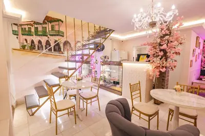 a restaurant with tables and chairs and a staircase at CASA HADASA in Cartagena de Indias