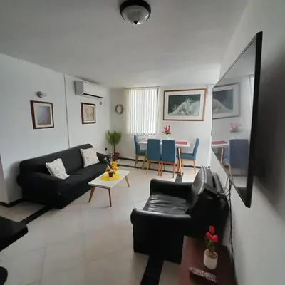 a living room with a couch and a table at Acogedor Apartamento Cartagena in Cartagena de Indias