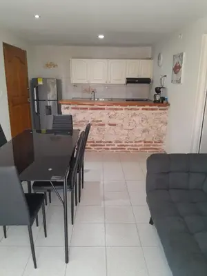 a kitchen and dining room with a table and chairs at Condominio en la Playa de Crespo in Cartagena de Indias