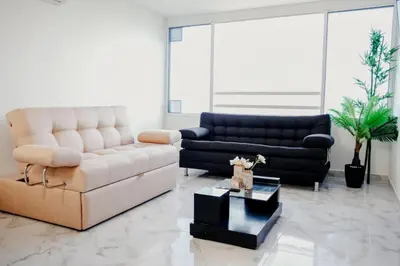 a living room with two couches and a table at Linda vista y excelente ubicación in Cartagena de Indias