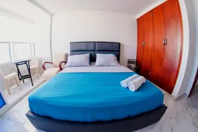 a bedroom with a large blue bed with two towels at Linda vista y excelente ubicación in Cartagena de Indias