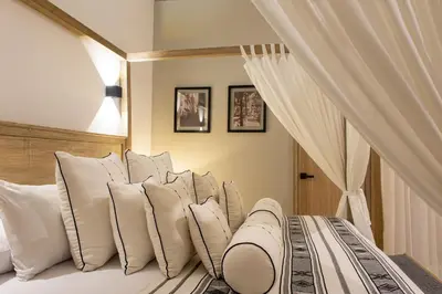 a bedroom with a bed with white pillows at Sol de Alba Hotel Boutique in Cartagena de Indias