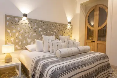 a bedroom with a large bed with white pillows at Sol de Alba Hotel Boutique in Cartagena de Indias