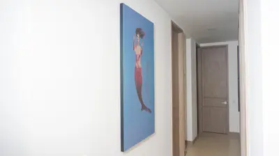 a painting of a mermaid on a wall in a hallway at Magico Apartamento Frente al Mar 4 Habitaciones PAZ345 in Coveñitas