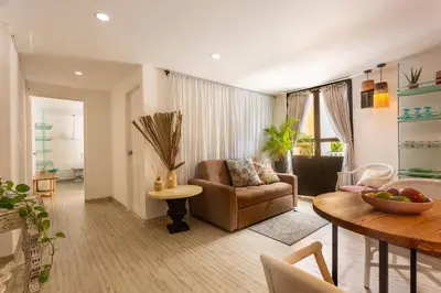 a living room with a couch and a table at Al Alma Apart-Suites in Cartagena de Indias