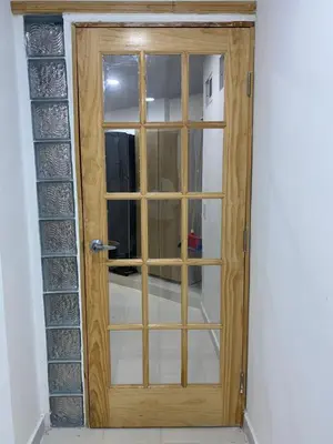 a wooden door with a window in a room at Hostal La Princesa in Cartagena de Indias
