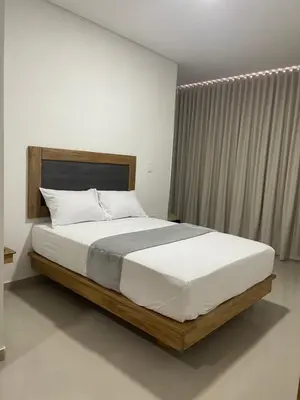 a bedroom with a large bed with a large window at Hotel El Faro - Desayunos incluidos - Manga, Cartagena in Cartagena de Indias
