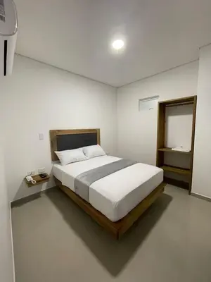 a bedroom with a large white bed and a window at Hotel El Faro - Desayunos incluidos - Manga, Cartagena in Cartagena de Indias