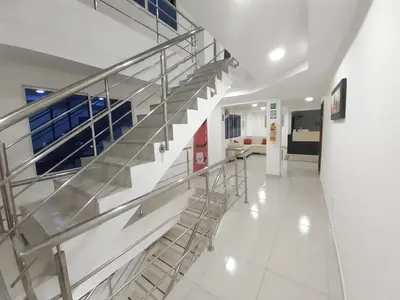 a hallway with metal stairs in a building at Hotel Don Jose in Ciénaga