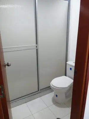 a bathroom with a toilet and a glass shower at Hotel Don Jose in Ciénaga