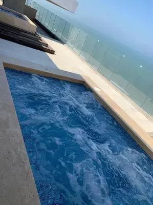 a swimming pool with blue water in a building at Cerca al Hotel Americas Ctgna Spiaggia Morros Piscina playa in Cartagena de Indias