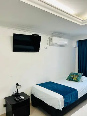 a bedroom with a bed and a flat screen tv at Apartamento in Cartagena de Indias