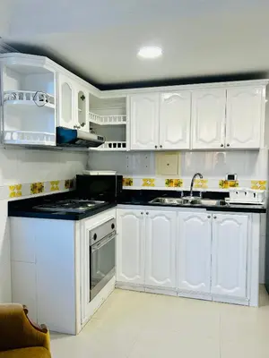 a white kitchen with white cabinets and a sink at Apartamento in Cartagena de Indias