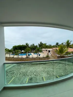 a view of the beach from the window of a building at Acogedor apartamento con vista al mar en coveñas in Coveñas