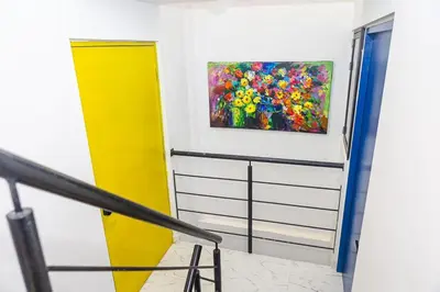a painting hanging on a wall next to a door at Casa Colors in Cartagena de Indias