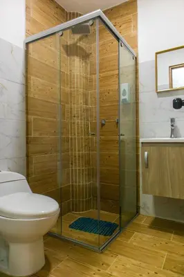 a glass shower in a bathroom with a toilet at Casa Colors in Cartagena de Indias
