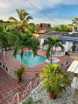 a resort with a swimming pool and palm trees at VILLA MARIA in Turbaco