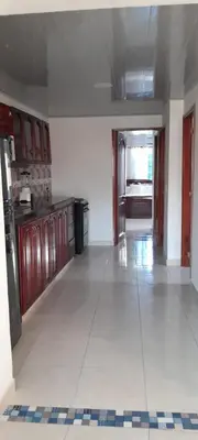 a large kitchen with a large white tile floor at VILLA MARIA in Turbaco