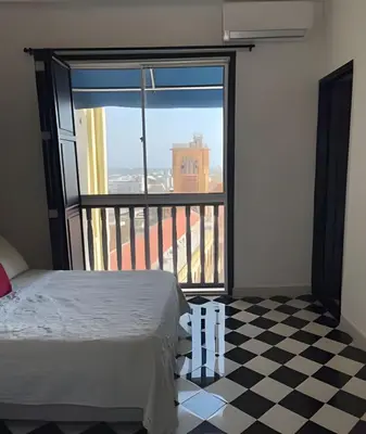 a bedroom with a bed and a checkered floor at 704 Puesta de sol apto en Cartagena in Cartagena de Indias