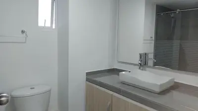 a white bathroom with a toilet and a sink at Apartamento 3 Carabelas Cartagena Piso 16 in Cartagena de Indias