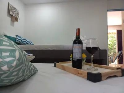 a bottle of wine and a glass on a table at CABAÑA EN ISLA FRENTE A CARTAGENA in Cartagena de Indias