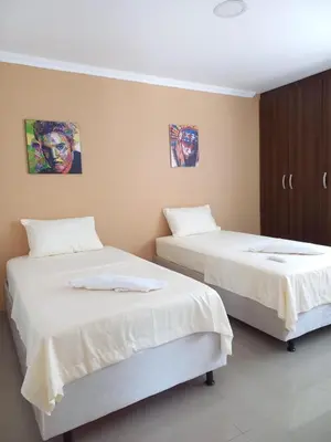 two beds sitting next to each other in a room at Hermosa casa amoblada in Barranquilla