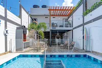 a house with a swimming pool and a house at Confort+Relax= Romántico ApartaEstudio + Piscina + Parqueadero in Santa Marta