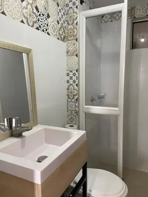 a white bathroom with a sink and a toilet at Taller del artista II in Cartagena de Indias