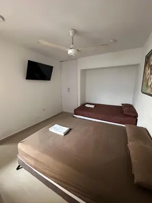 a bedroom with two beds and a flat screen tv at APARTAMENTO in Cartagena de Indias