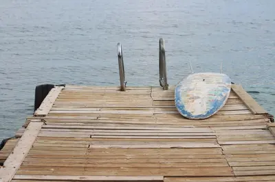 a boat sitting on top of a dock on the water at CasaCoral Hotel in Isla Fuerte