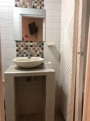 a bathroom with a sink and a mirror at Martinica Hostel in Cartagena de Indias
