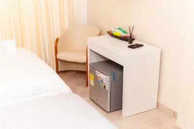 a room with a bed and a table and a chair at Abel Boutique House in Cartagena de Indias