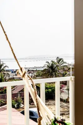 a balcony with a hammock and a view of the ocean at Villa Nuevo Amanecer Santa Verónica in Santa Veronica