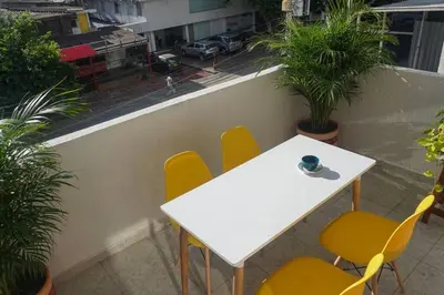 a white table and yellow chairs on a balcony at Azul de Bocagrande in Cartagena de Indias