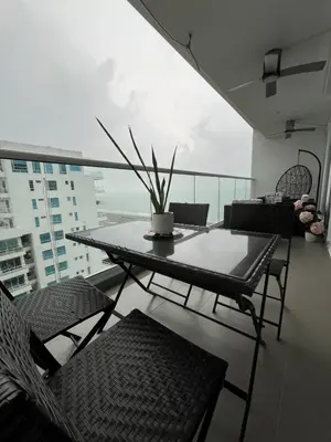 a table and chairs in a room with a window at Morros Cartagena junto al Hotel las Américas Edificio Spiaggia salida a playa in Cartagena de Indias