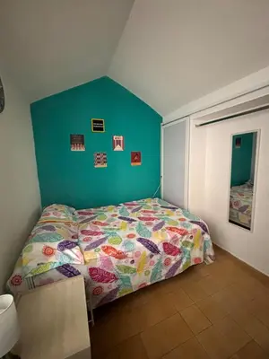 a bedroom with a bed and a blue wall at Casa Grace Apto con vista al mar in Cartagena de Indias