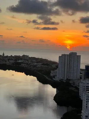 a sunset over the water in a city at La mejor vista al mar y ubicacion en Cartagena in Cartagena de Indias