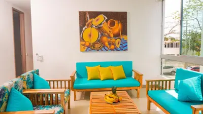 a living room with blue furniture and a painting on the wall at Magico Apartamento Frente al Mar 3 Habitaciones PAZ224 in Coveñitas