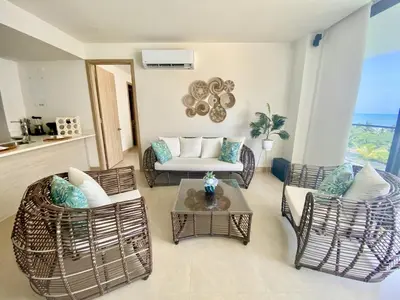 a living room with chairs and a couch and a table at Apartamento de Lujo Morros Zóe - Manzanillo - Cartagena in Cartagena de Indias