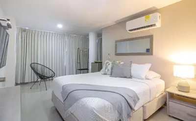 a bedroom with a large white bed in a room at Bahari Cartagena Suites in Cartagena de Indias