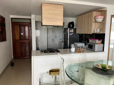 a kitchen with a glass table and a counter top at Apartamento con vista al mar in Cartagena de Indias