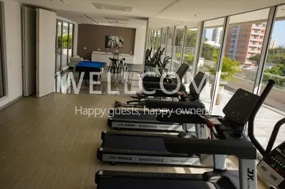 a gym with a stack of books on a treadmill at Loft Distrito 90 in Barranquilla