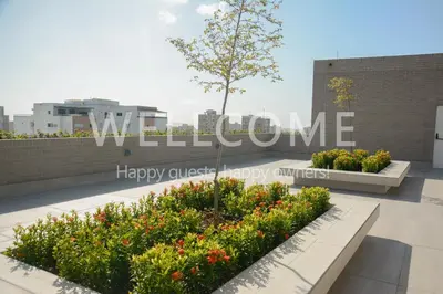 a sign on the roof of a building with flowers at Loft Distrito 90 in Barranquilla