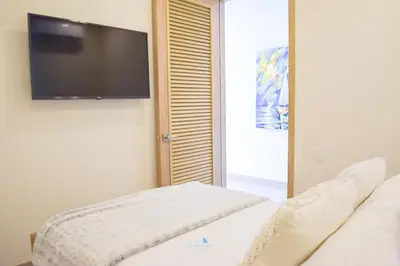 a living room with a tv and a couch at Apartamento vista al Mar lateral Panoramic View,Spectacular building,Pools, Beach Morros zoe ultimo piso in Cartagena de Indias