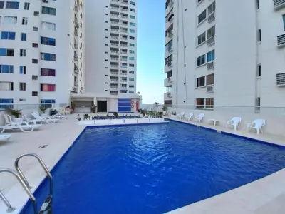 a swimming pool in the middle of two buildings at Apartamento 1804 Cartagena Bocagrande hermosa vista a 1 cuadra de la playa in Cartagena de Indias