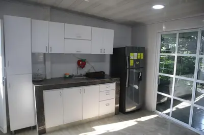 a kitchen with white cabinets and a refrigerator at Penthouses La Fe in Cartagena de Indias