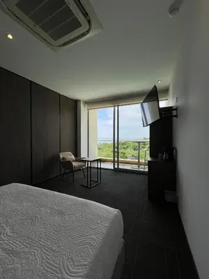 a hotel room with a bed and a table and a television at Hotel Explore Caño Dulce in Tubará