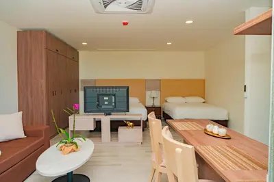 a room with a living room with a dining table and a bedroom at Hotel Explore Caño Dulce in Tubará